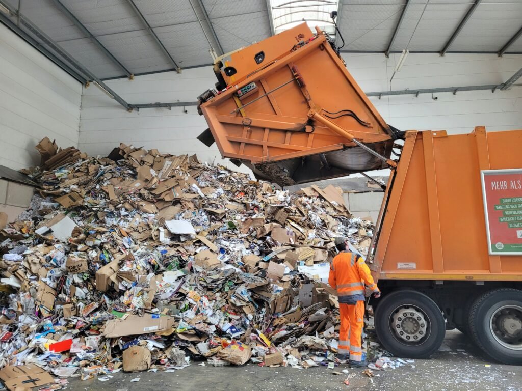 a man standing next to a pile of trash